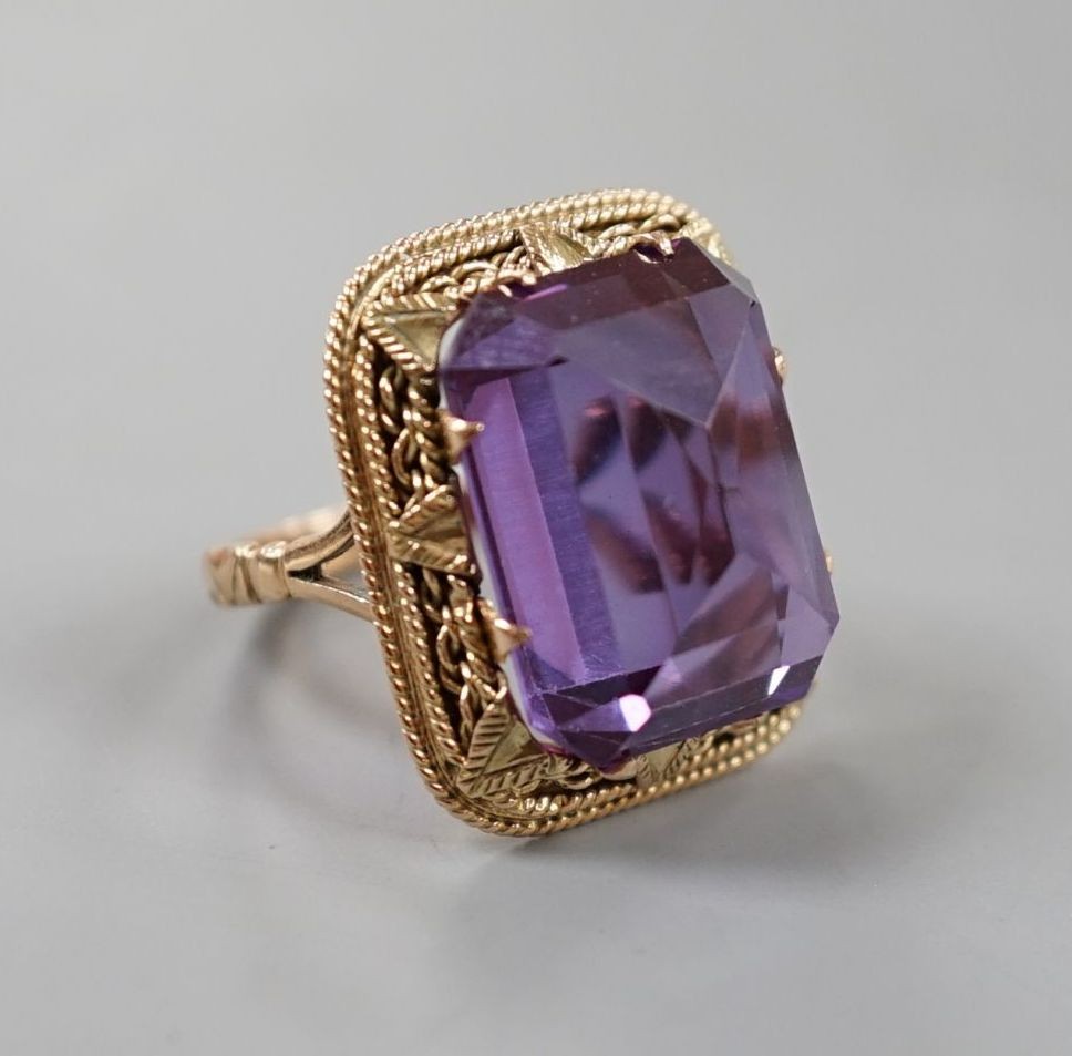 A 20th century Egyptian yellow metal and fancy cut synthetic colour change corundum set dress ring, size M/N, gross weight 9 grams.